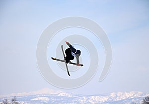 Ski crossover off a big jump in hanazono park