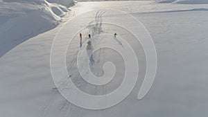 Ski-doo pull skiing on snow surface aerial view