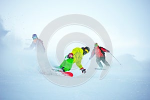 Ski downhill concept with group of snowboarders