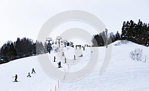 Ski field large white snow on slopes. Ski slopes snow. Winter banner panorama of slope at ski resort, people skiing,