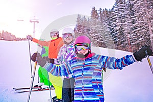 Ski girl happy portrait lifting hands with friends