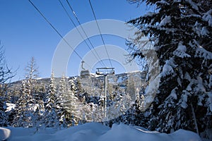 Ski gondola lift in mountains ski attraction. Mountains winter landscape view