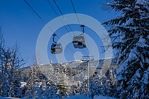 Ski gondola lift in mountains ski attraction. Mountains winter landscape view