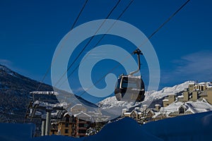 Ski gondola lift in mountains ski attraction. Mountains winter landscape view. Ski resort
