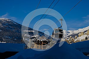 Ski gondola lift in mountains ski attraction. Mountains winter landscape view. Ski resort