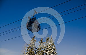 Ski gondola lift in mountains ski attraction. Mountains winter landscape view. Ski resort