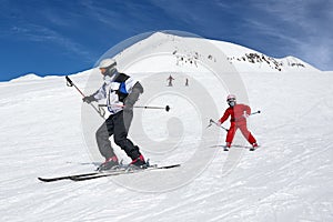 Ski instructor teaches to ride. The child repeats teacher.