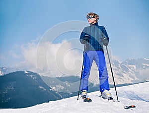 Ski instructor young man on the top of snow hill