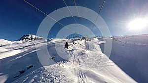 A Ski lift ascending a mountain in the Alps,