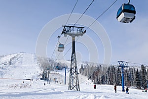 Ski lift, cable car funicular with open cabin on the background