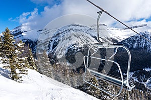 Ski Lift Chair With View of Snowy Mountains