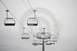 Ski lift in clouds. Chairlift  in Swiss alps in Switzerland Jungfrauregion