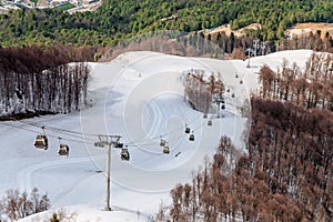 Ski lift of Gorky Gorod mountain ski resort at spring. Sochi, Russia. Scenic landscape
