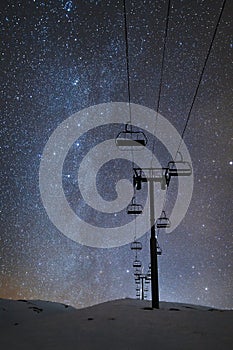 Ski lift at night under the stars in the sky