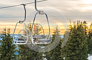 Ski lift with seats going over the snow mountain in ski resort