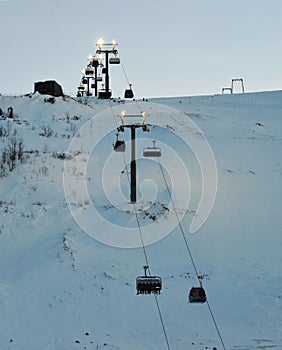 Ski lift in the ski resort Big Wood. Polar night, dusk, adverse weather conditions