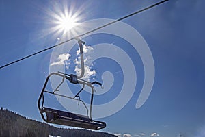 ski lift at a ski resort early in the morning illuminated by the sun.