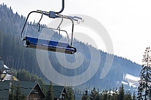 ski lift at a ski resort early in the morning illuminated by the sun.