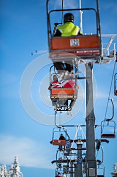 Ski lift with skiers being carried up the hill