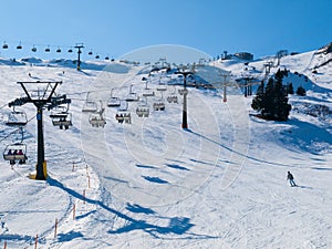 Ski lift and slopes in alpine winter resort