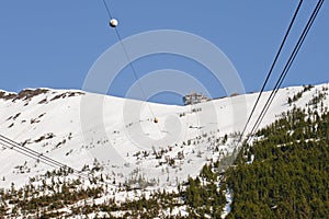 Ski lift in snowy mountains