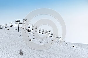 Ski lift on snowy slope at ski resort