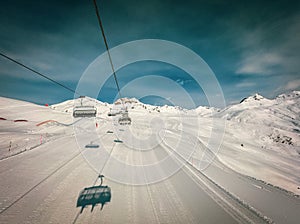 A ski lift travels over deserted ski slopes