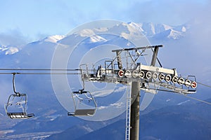 Ski lift on winter mountains background