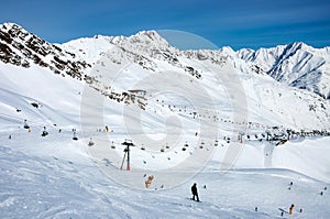 Ski lifts, skiers and snowboarders in Solden, Austria