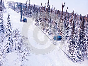 Ski lifts Winter mountains with snowy forest, aerial top view