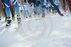 Ski marathon - de-focused view of many legs of sportsmen running on snow