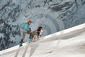 Ski mountaineering a girl with her dog