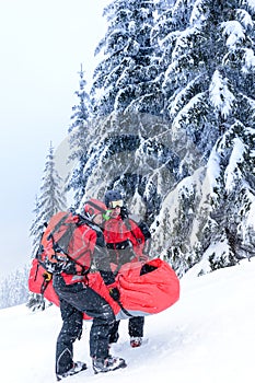 Ski patrol carry injured person in stretcher photo