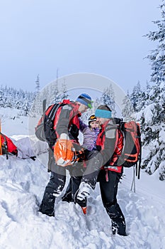 Ski patrol carry injured woman skier stretcher