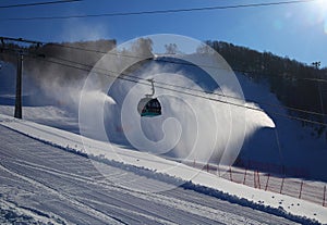 Ski piste and gondola lift and snow guns operating