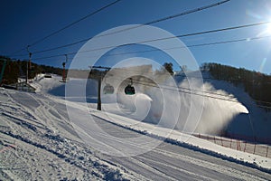 Ski piste and gondola lift and snow guns operating