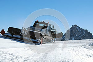 Ski piste snow groomer machine on mountain