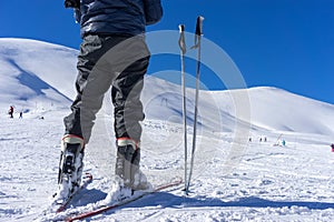 Ski poles near a skier on the mountain Falakro, in Greece.