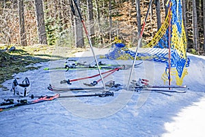 ski poles and skis on a snowy slope on day.