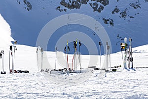 Ski poles in snow. Skiing equipment against snowy mountain in sk