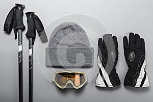 Ski poles with woolly hat goggles and gloves