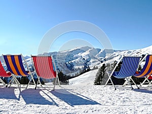 After ski relaxation sunbeds in winter mountain scenery
