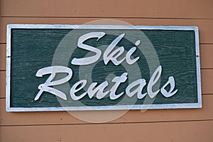 Ski rentals wooden sign on the building