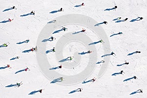 Ski resort. Aerial view of skiers. Winter sports. Snow slope in the mountains for sports. Group training. Exercise with friends.