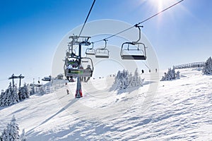 Ski resort Kopaonik, Serbia, slope, people on the ski lift, sun