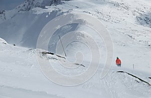 Ski resort in Low Tatras in Slovakia. Young female skier skiing and fight with huge wind from side. Ski resort Jasna Chopok,