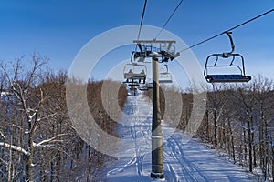 Ski resort in Russia, trails with snow-covered trees and a chairlift