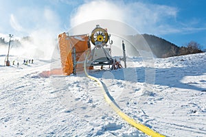 Ski resort with snow gun making new surface.