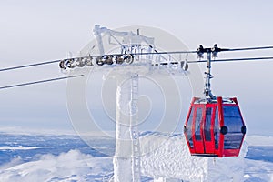 Red cable car in a ski resort in the Alps. Red gondola funicular in a ski resort, sweden, frosty sunny day