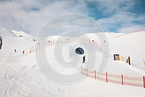 Ski resort in winter Alps. Skiers ride down the slope. Tux, Hintertux, Austria